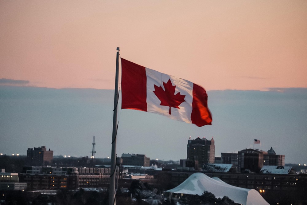 fotografía de una bandera de Canadá en una ciudad